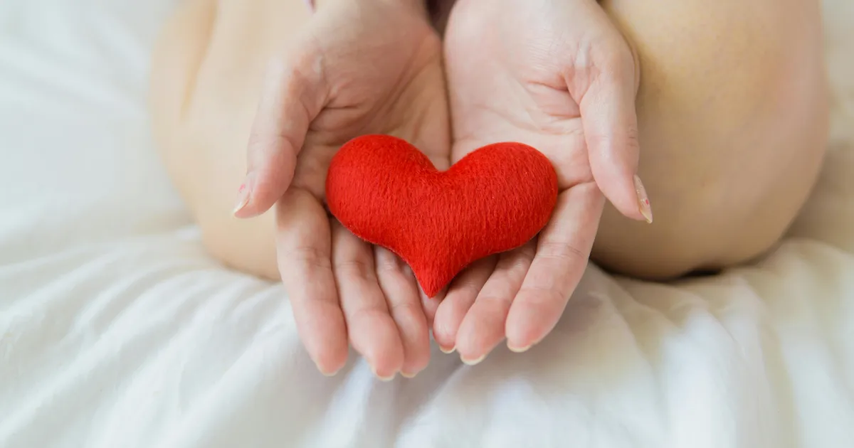 Hands holding a red heart, representing home health and hospice care billing